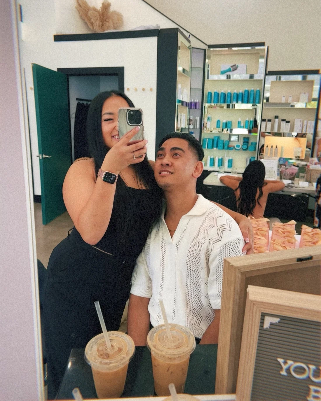 Rikki and Abraham, the two Besmi co-founders, in a mirror selfie at a salon